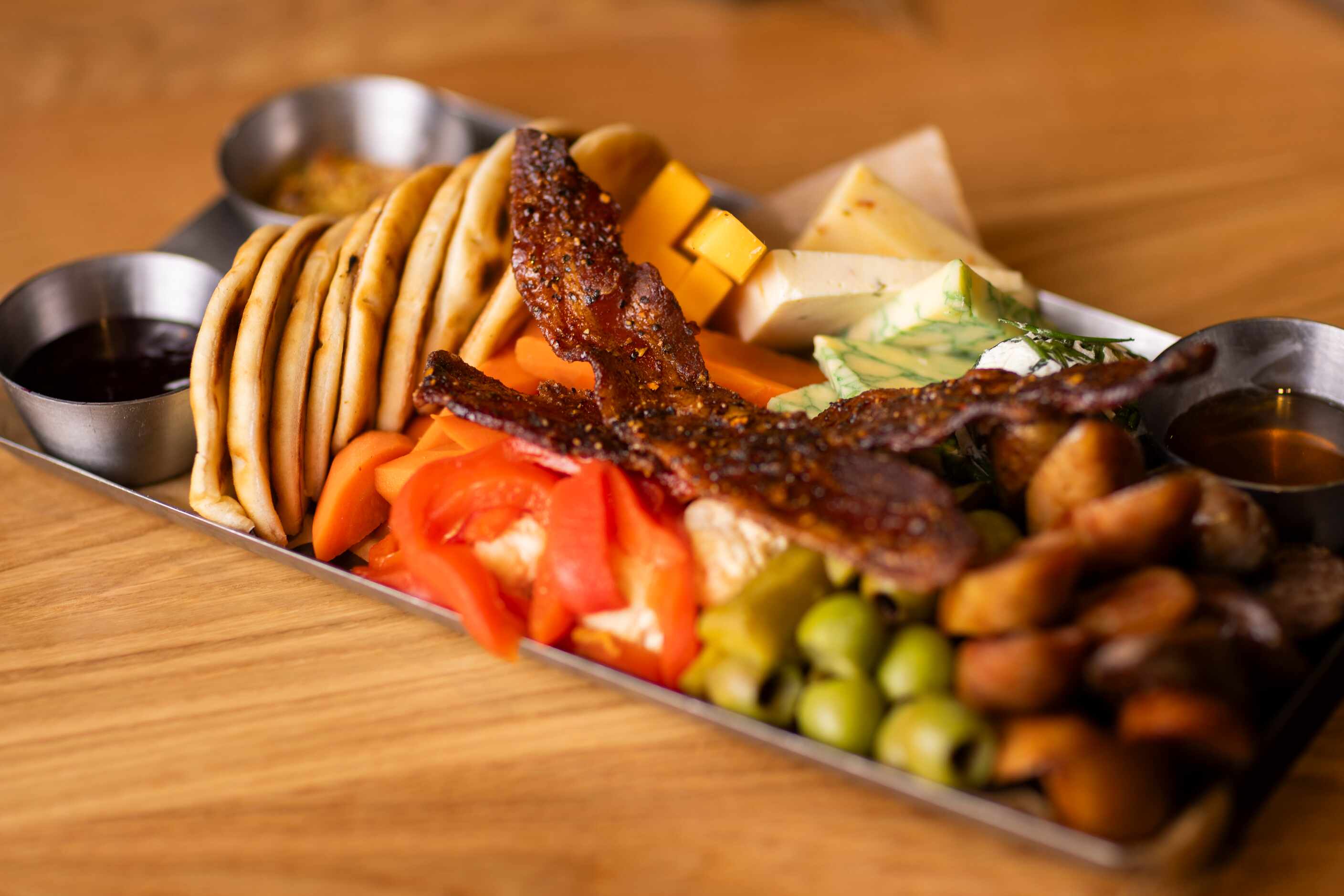 Bacon sits on top of the Meat and Cheese Rodeo Cheeseboard served at the new Cowboy Chow...