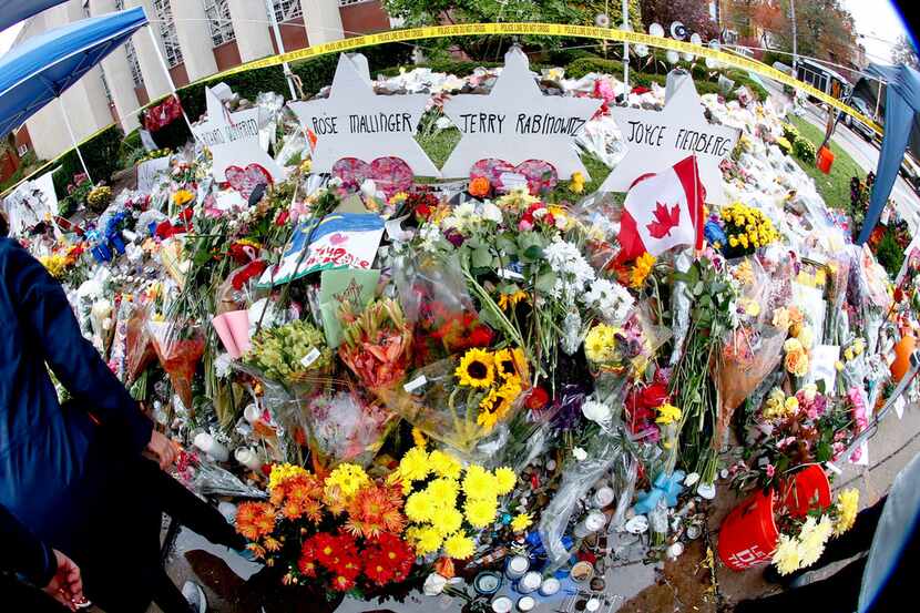 This photo made with a fisheye lens shows hundreds of bouquets of flowers stacked in front...