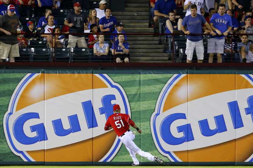 Texas Rangers right fielder Alex Rios (51) has to change direction and run down a fly ball...