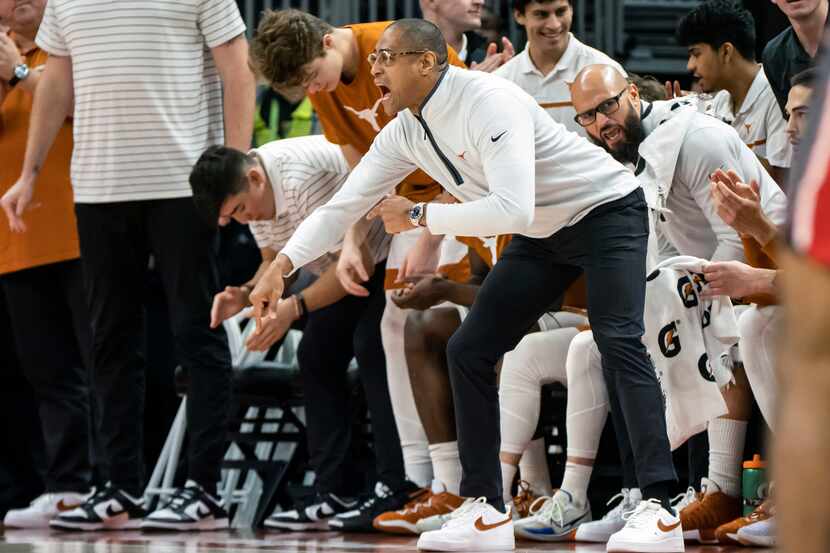 Texas acting head coach Rodney Terry, center, directs his team during the first half of an...