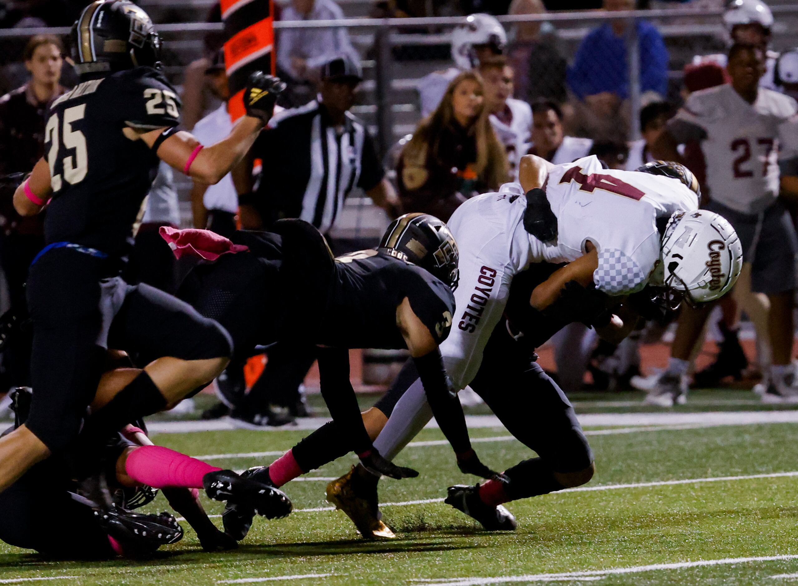 Frisco Heritage’s wide receiver Carsten Brewer (4) is brought down by The Colony defense...