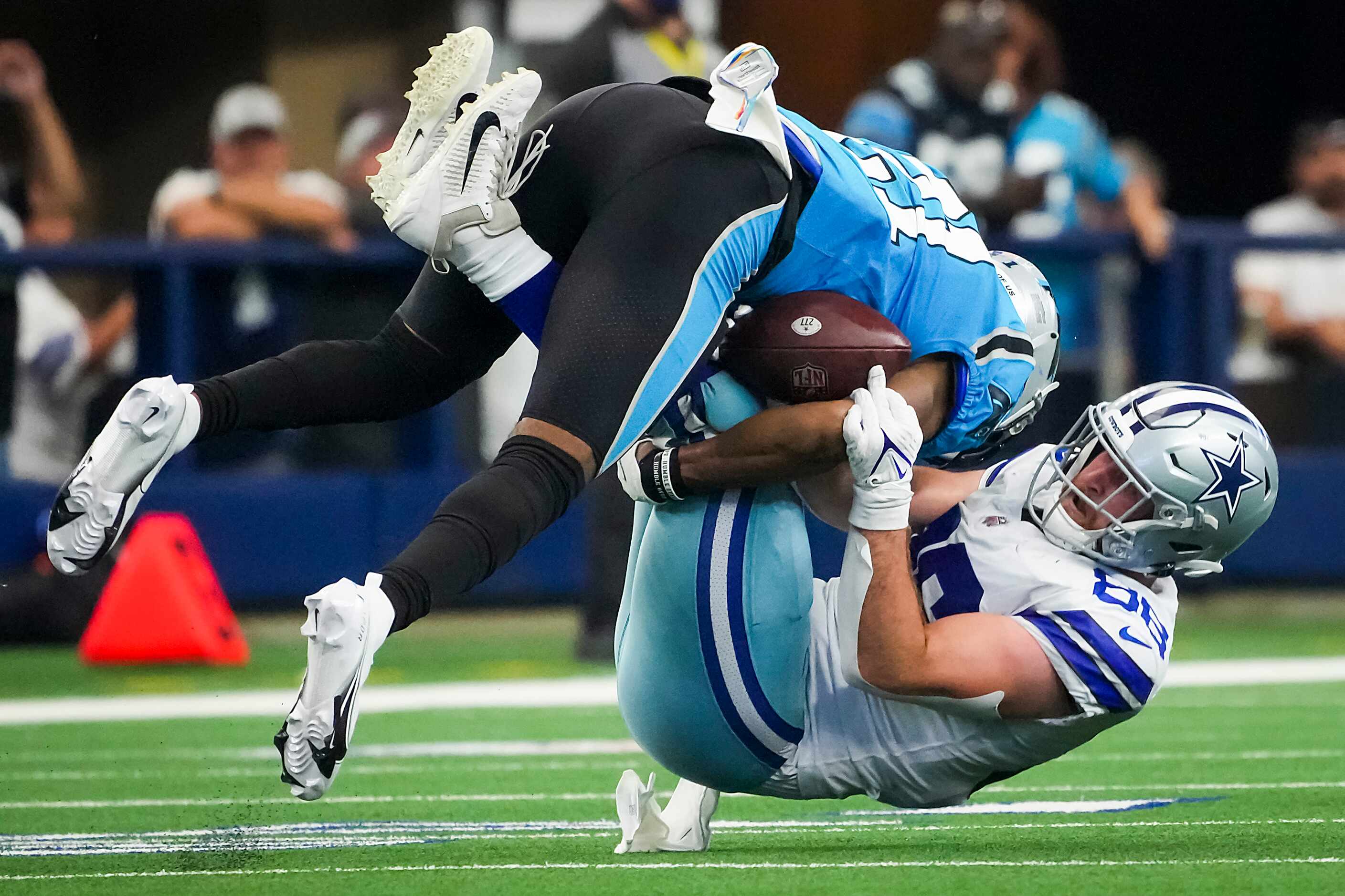 Dallas Cowboys tight end Dalton Schultz (86) is brought down by Carolina Panthers safety...