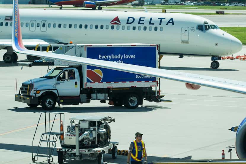  A Delta Air Lines jet taxis between two Southwest Airlines jets at Dallas Love Field....