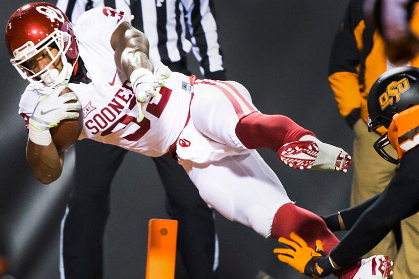 Oklahoma running back Samaje Perine (32) leaps into the end zone to score on 25-yard...