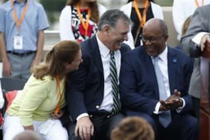 Philanthropist Mary McDermott Cook listens to former Dallas Mayor Mike Rawlings (center) and...