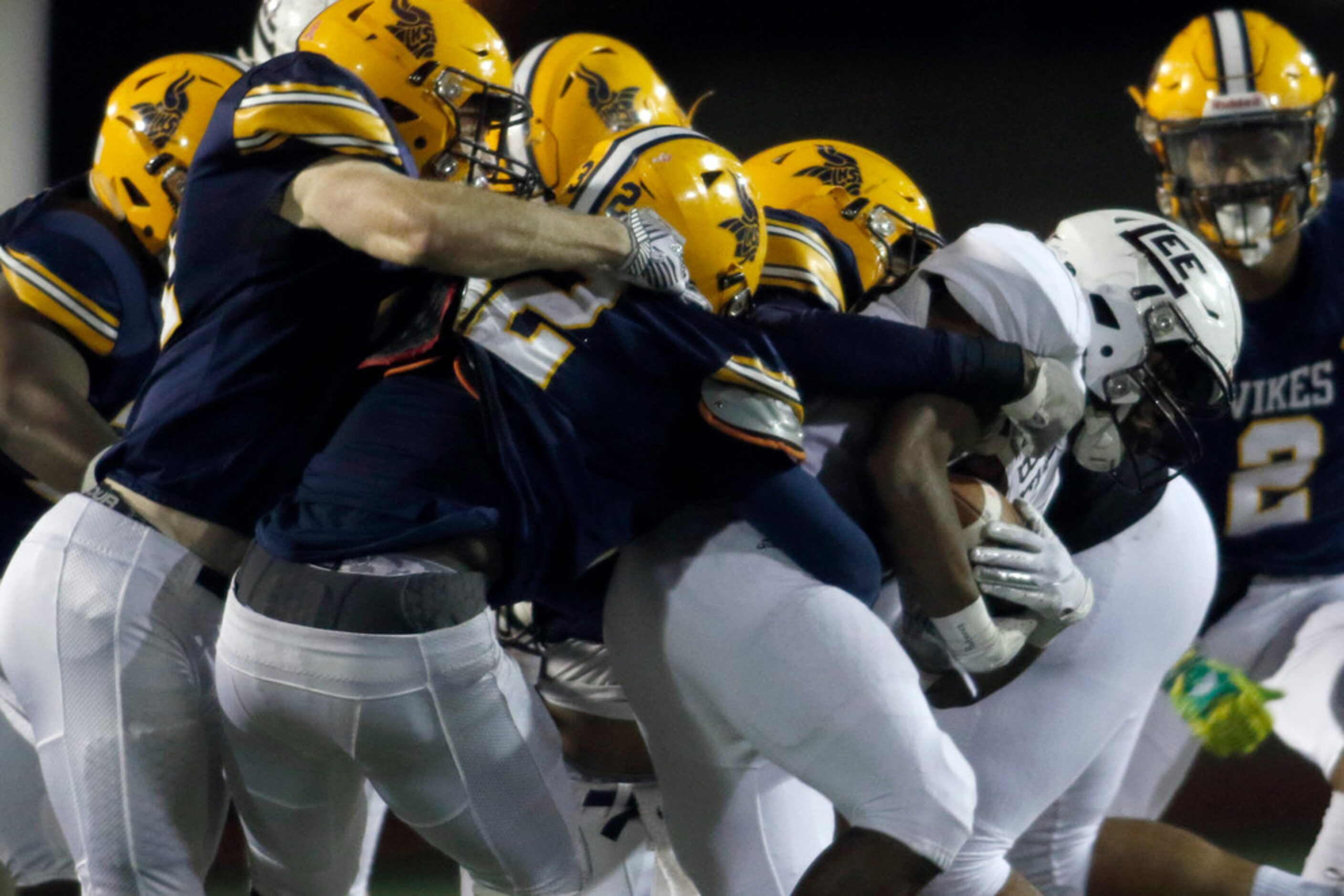 The Arlington Lamar defense swarms Midland Lee running back Makhilyn Young (22) during a...