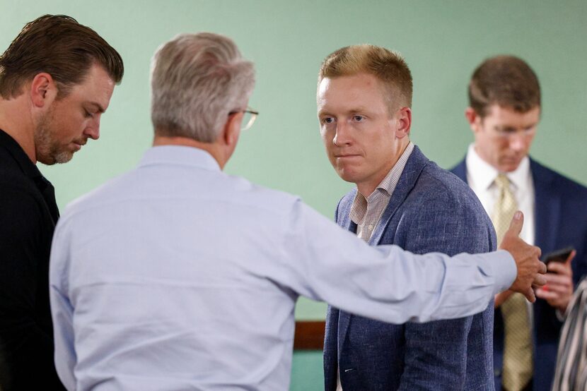 Patrick Todd, Todd Interests managing partner (right) speaks with his father and Todd...