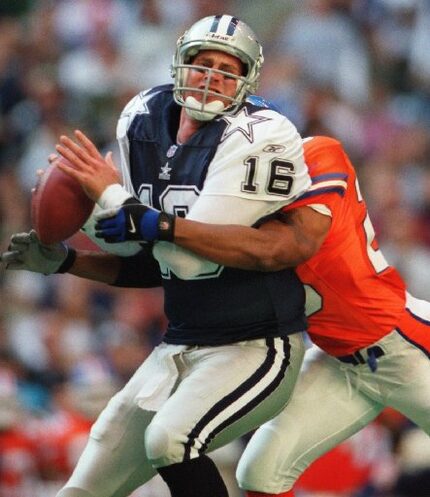  Cowboys quarterback Ryan Leaf #16) feels the crunch of the Denver Bronco defense as he is...