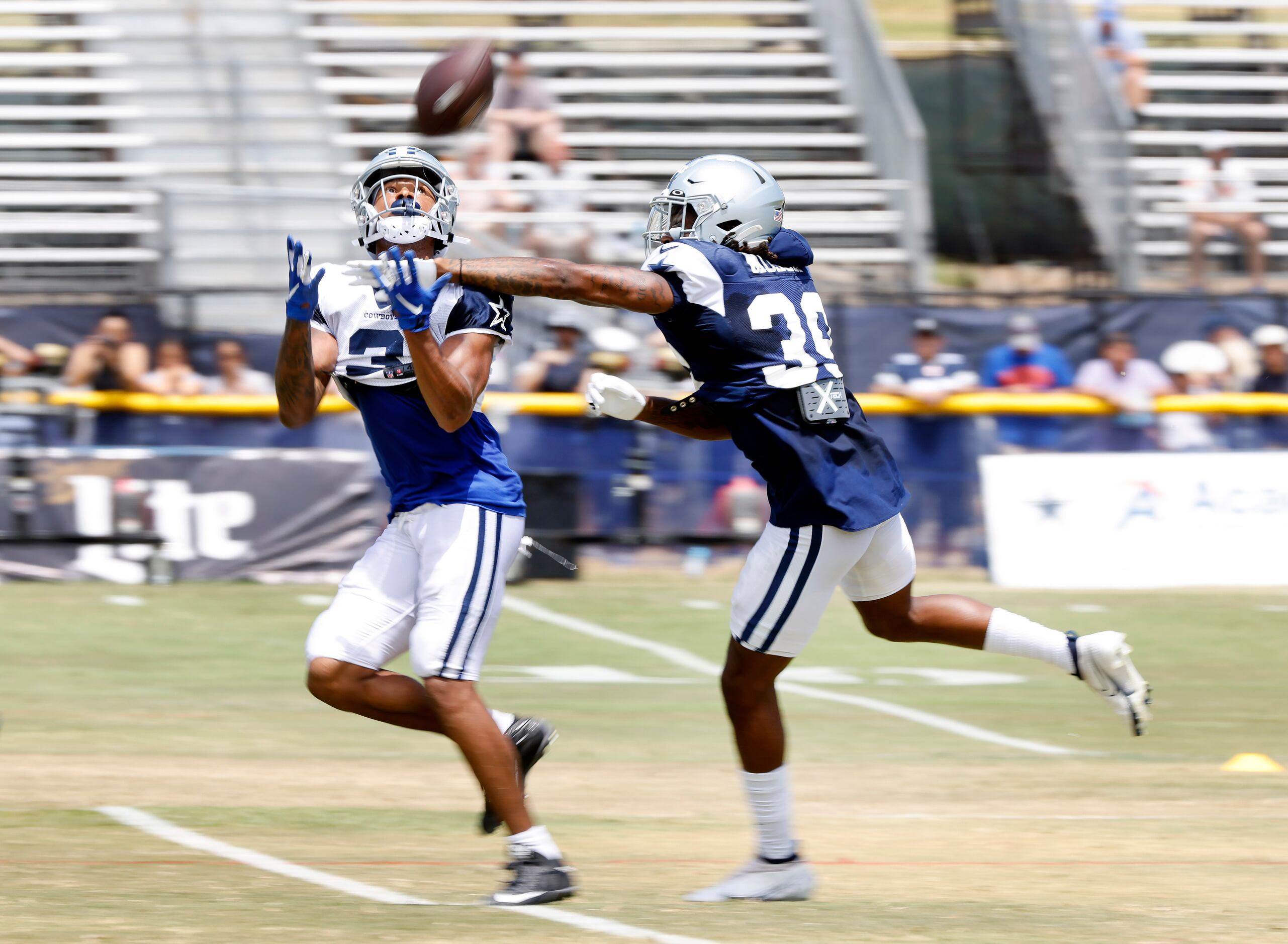 Dallas Cowboys wide receiver Dennis Houston hauls down a deep pass as he’s covered by...