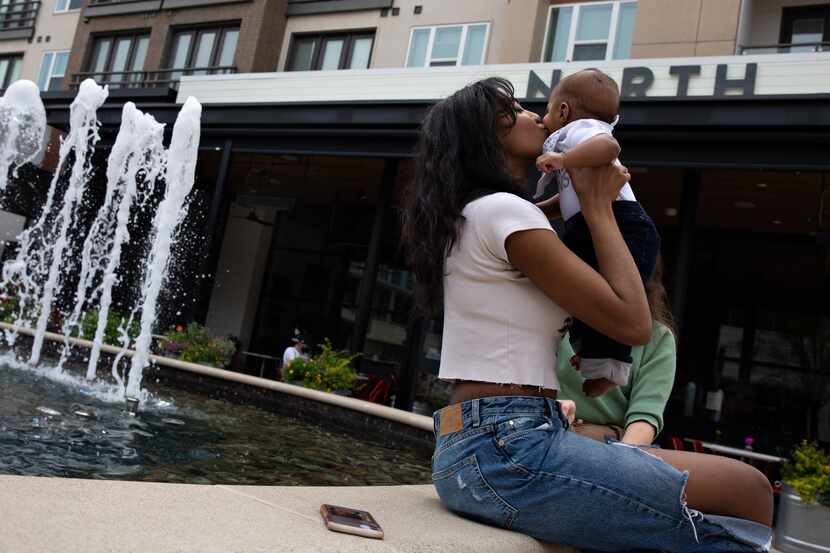 Malia Moore kisses her 4-month-old son, Micah, during an excursion on May 17, 2021 to Legacy...