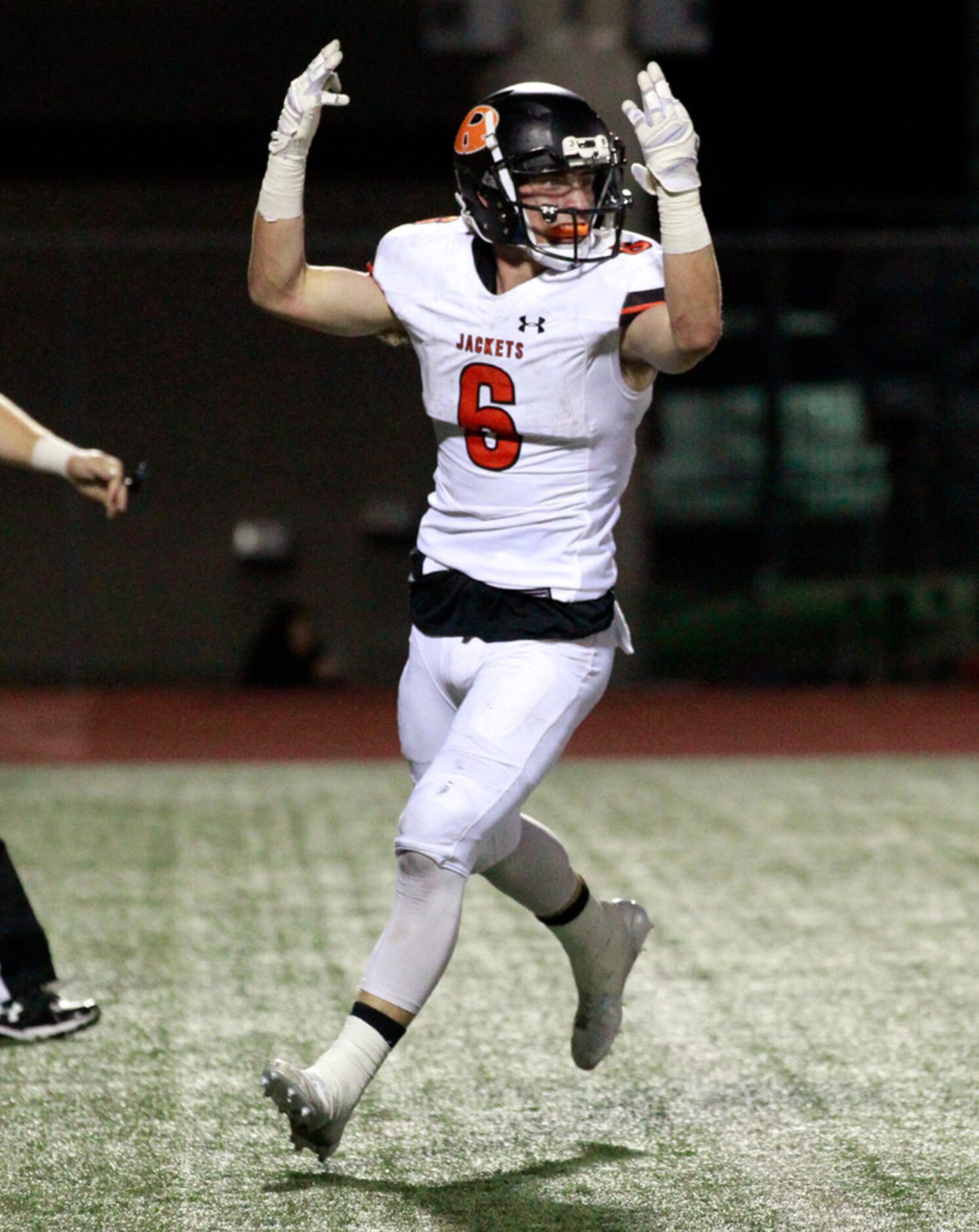 Rockwell's Zach Henry (6) signal's his touchdown during the first half of a high school...