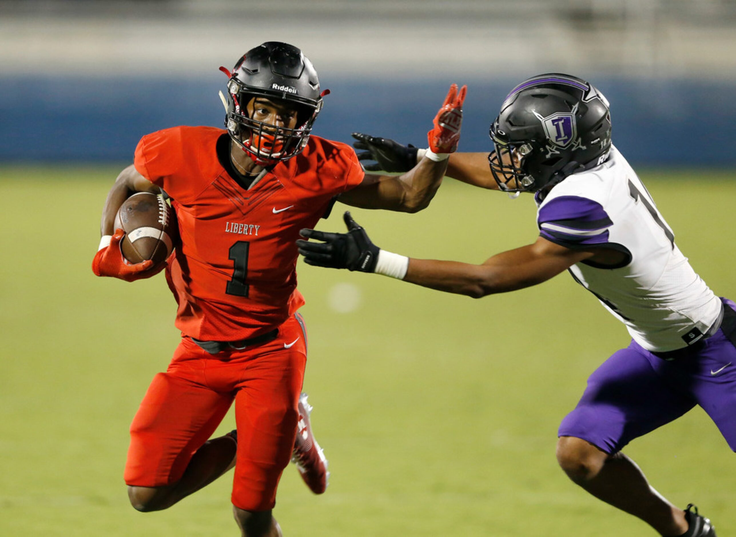 Liberty's Geomaih Lewis (1) attempts to break away from Independence's Caleb Ellis (14)...