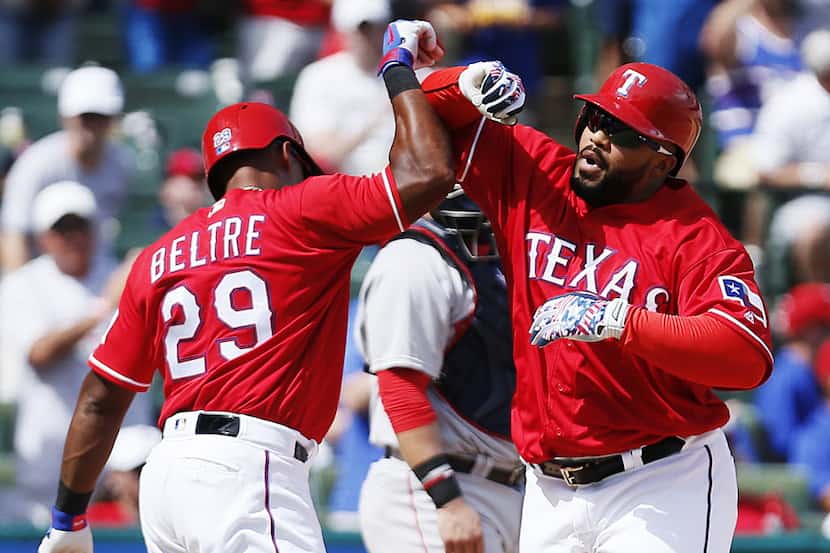 Texas Rangers designated hitter Prince Fielder, right, celebrates his two-run home run with...
