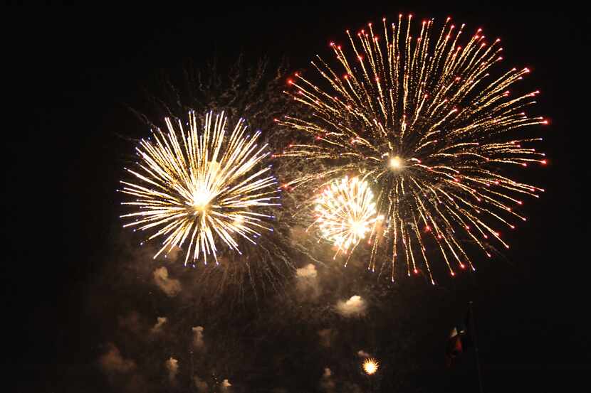Fireworks light up the sky over the Margaret Hunt Hill Bridge at Red, White and Boom on the...