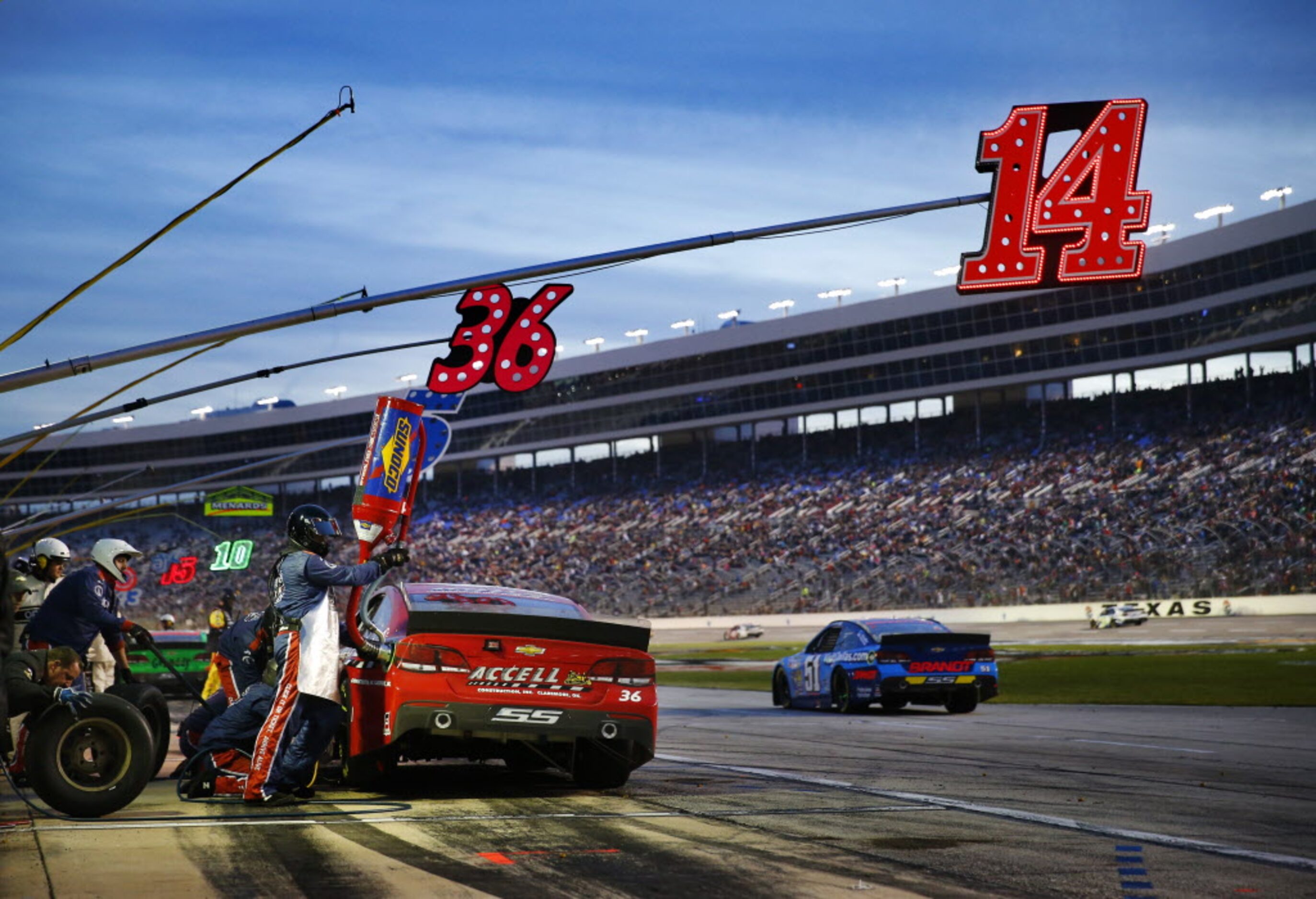 Sprint Cup Series driver Reed Sorenson (36) receives fuel during a late pit stop in the AAA...