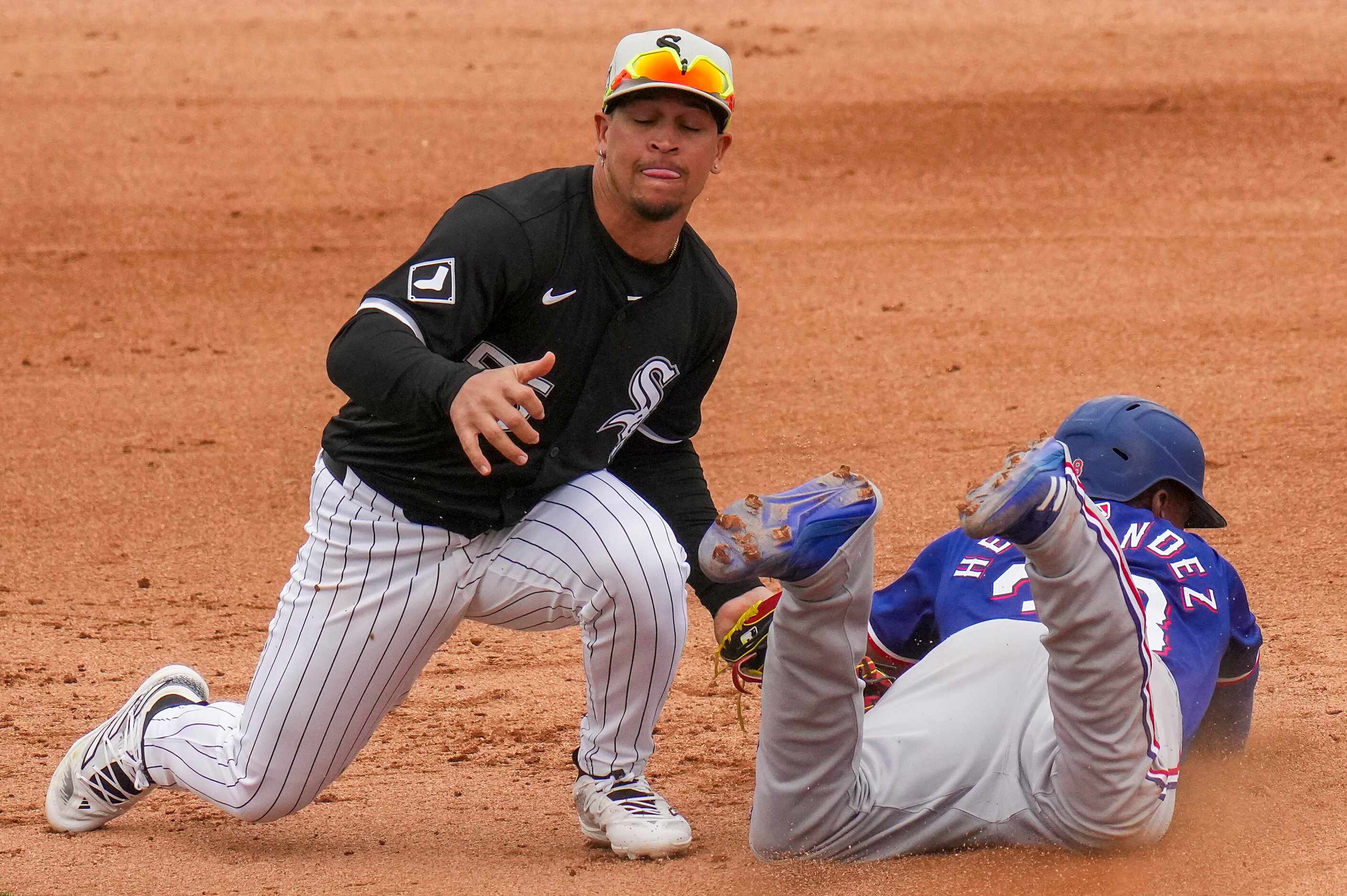 Chicago White Sox second base Jose Rodriguez applies the tag as Texas Rangers outfielder...