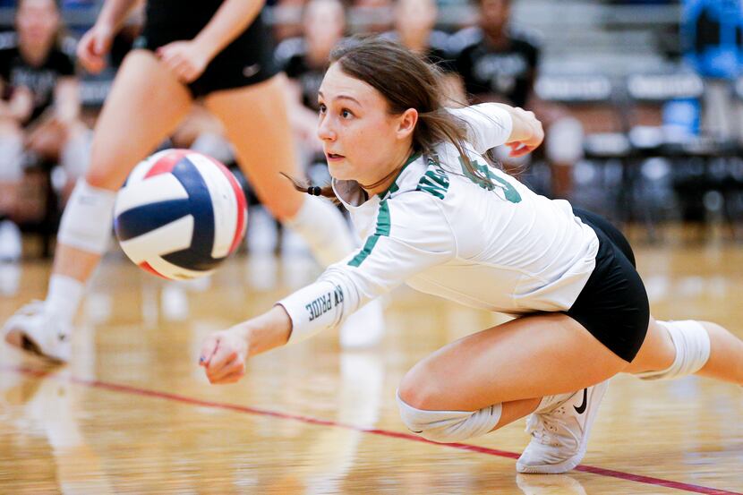 Waxahachie senior Baylee Whitehead (9)  dives for the ball during a match against Mansfield...