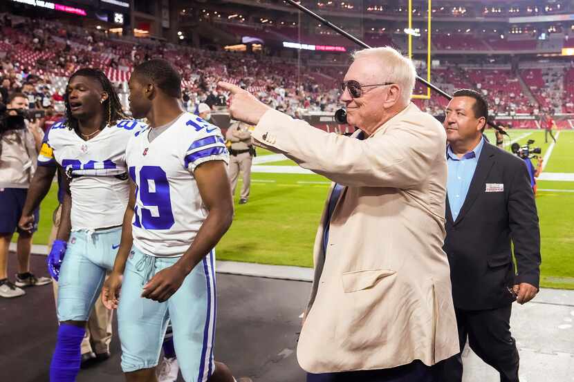 Dallas Cowboys owner and general manager Jerry Jones points to the crowd after the teams...