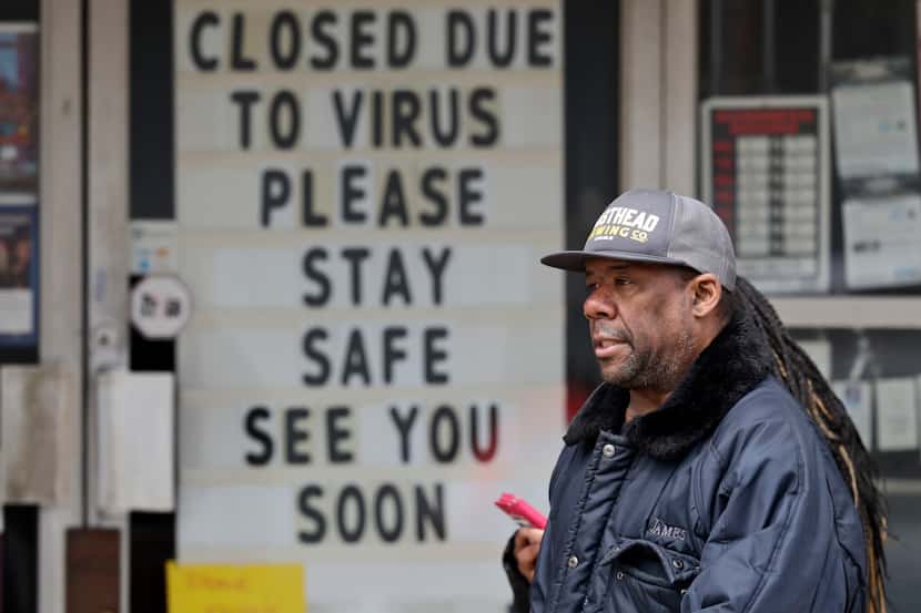 A man walks past a closed shop in Cleveland. Most workers who've been furloughed expect to...
