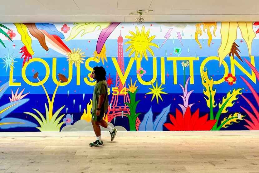 Artist Drigo Rodriguez walks by the mural he painted for Louis Vuitton.