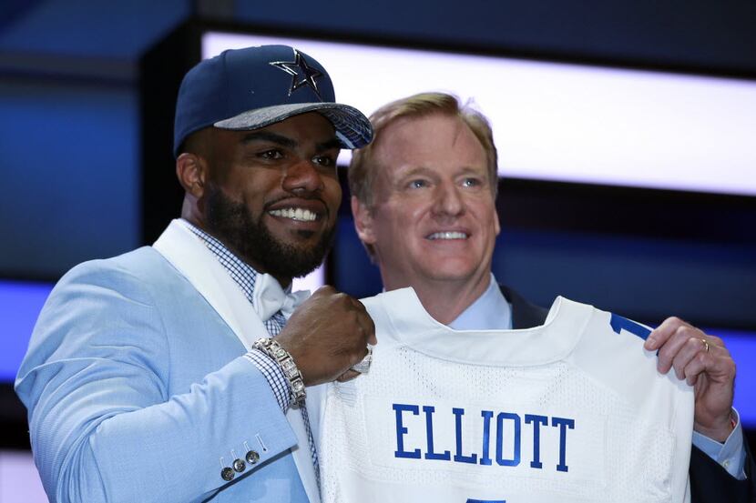 Ohio State’s Ezekiel Elliott poses for photos with NFL commissioner Roger Goodell after...