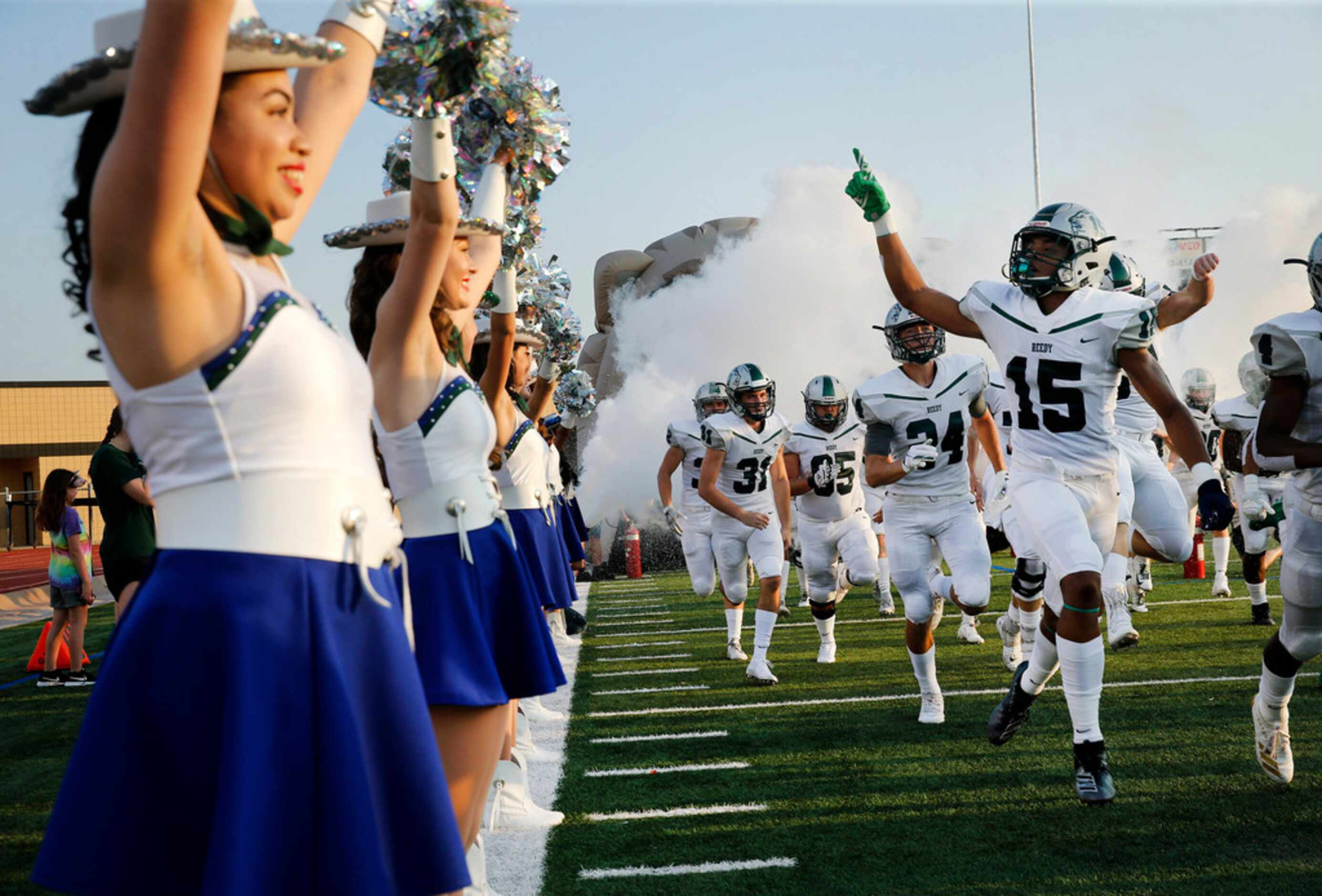 Frisco Reedy's Zion Washington (15) and the rest of the Lions take the field lined by the...