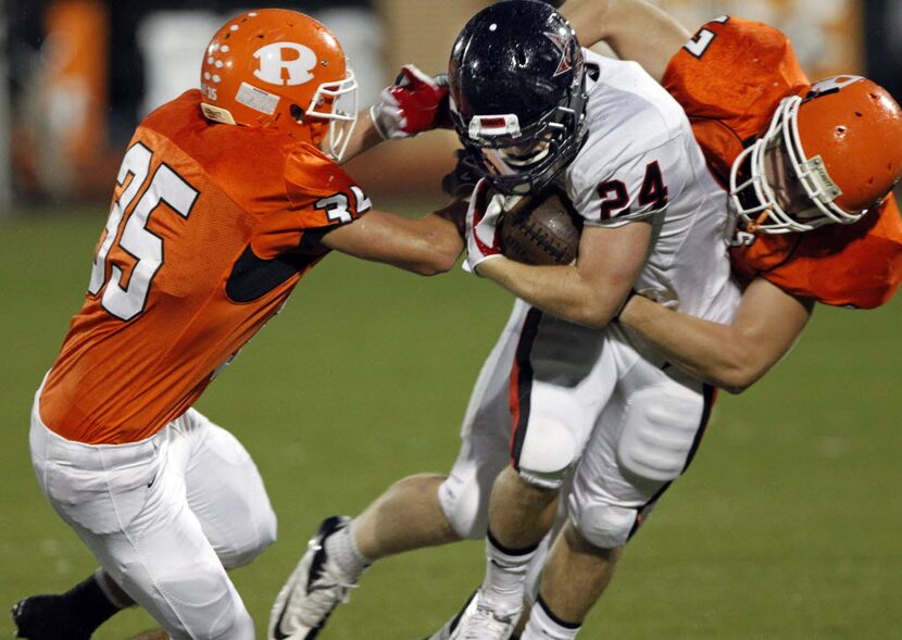 Rockwall High defenders Sean Hardenbrok (35) and Josh Rippy (47) stop Coppell High RB Luke...