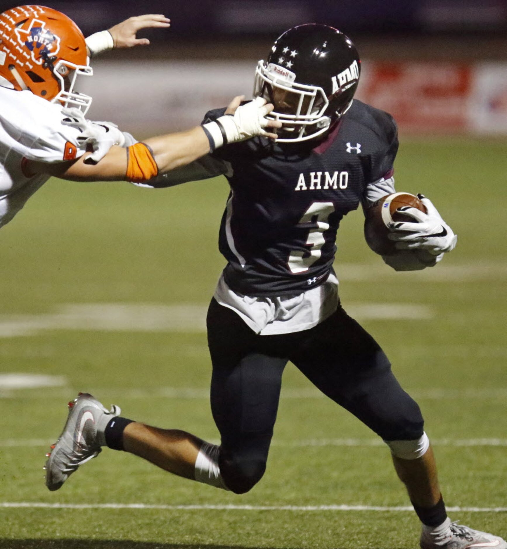 McKinney North High School linebacker Nathan Gifford (9)  gets the facemask of Wylie High...