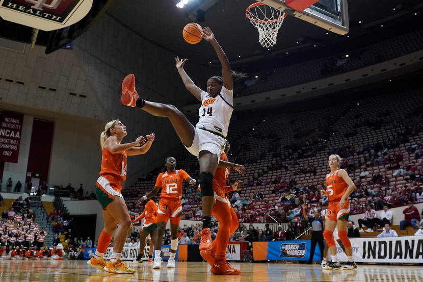 Oklahoma State's Taylen Collins (14) falls to the court after getting fouled by Miami's...
