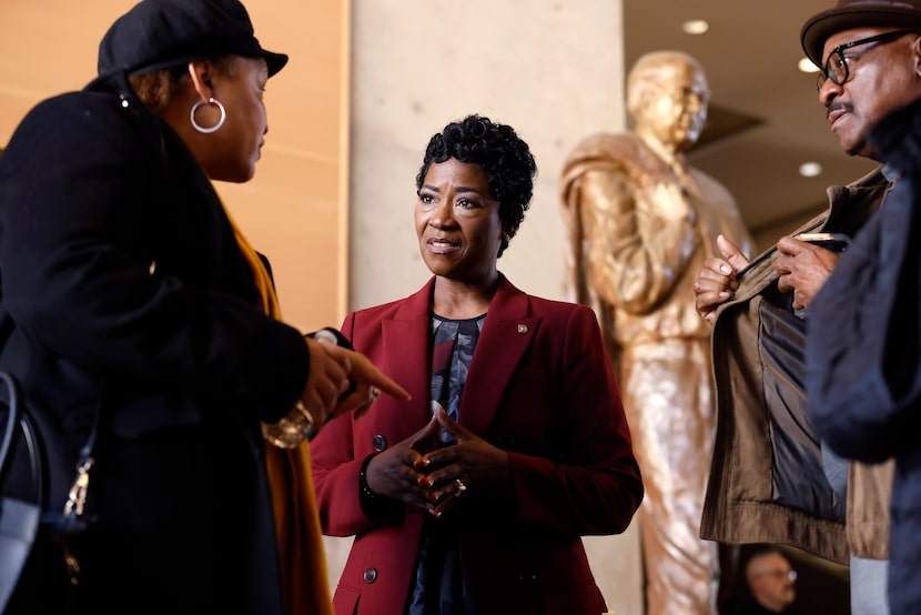 Dallas Interim City Manager Kimberly Bizor Tolbert (center) visits with Tomeji Miller (left)...