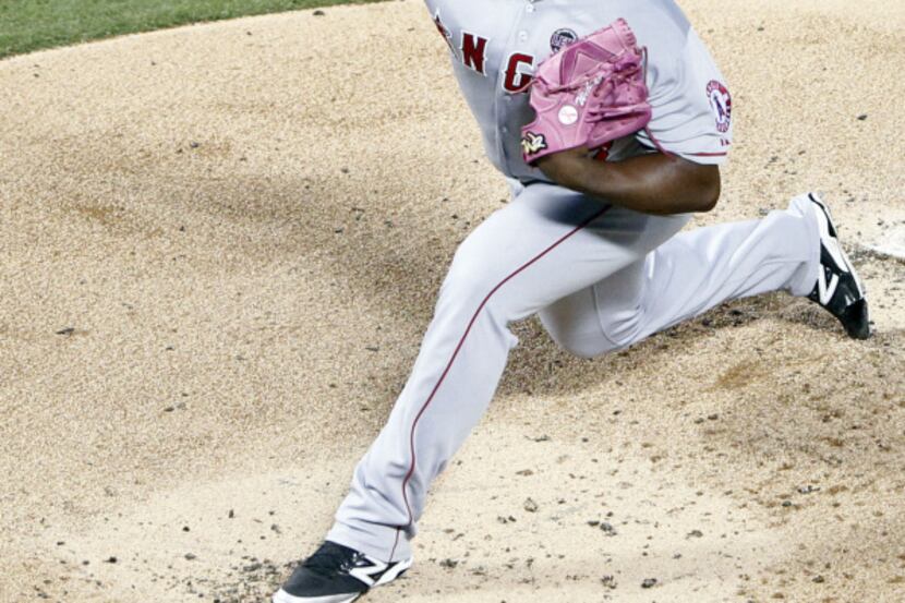 Texas Rangers shortstop Elvis Andrus (1) dives head first into third base after stealing...