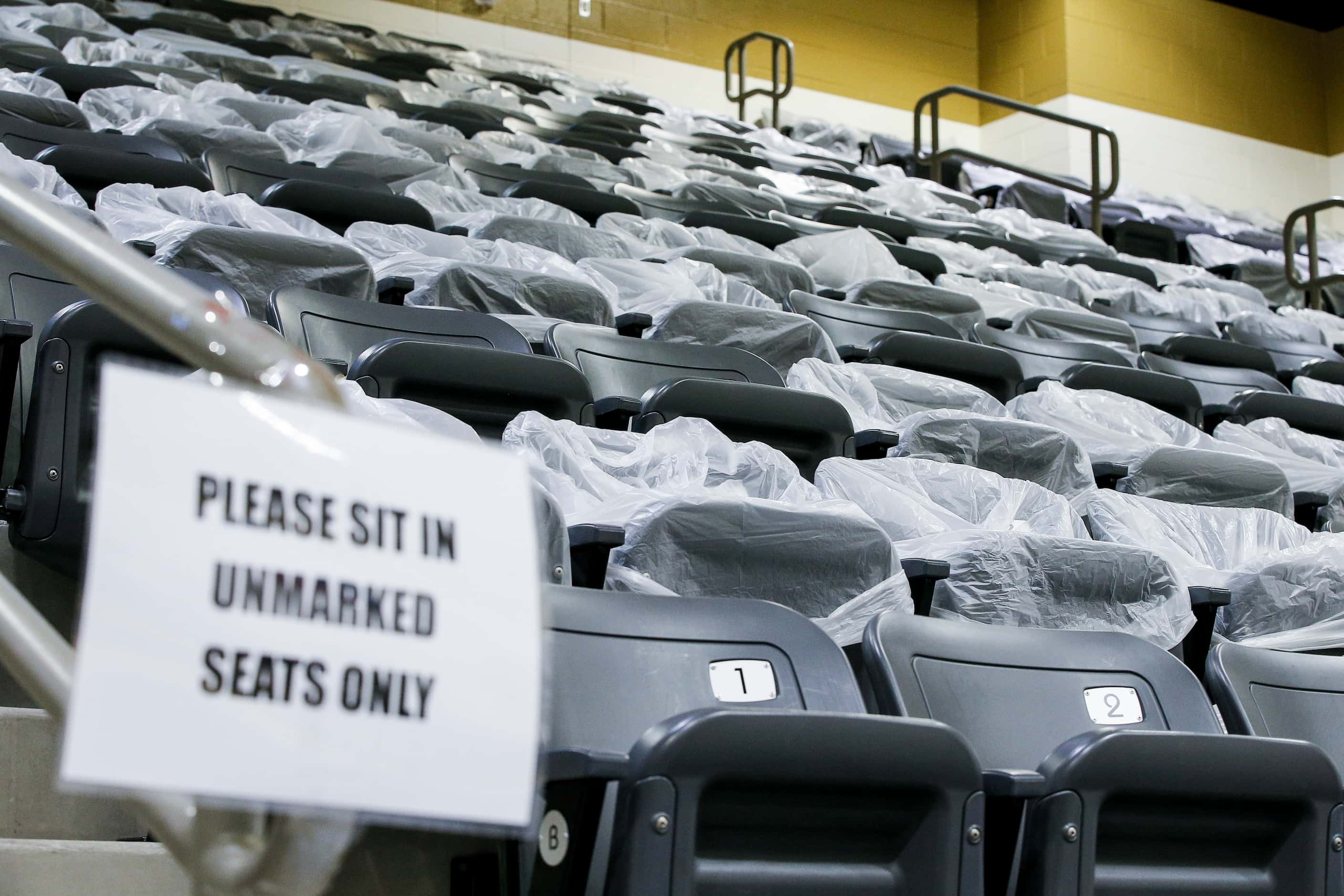 Seats are blocked off with plastic bags to enforce social distancing rules during a...