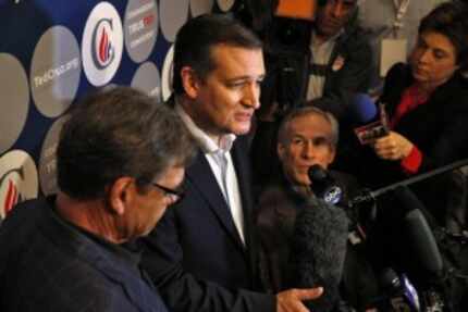  Republican presidential candidate Ted Cruz (center) speaks to the media with former Texas...