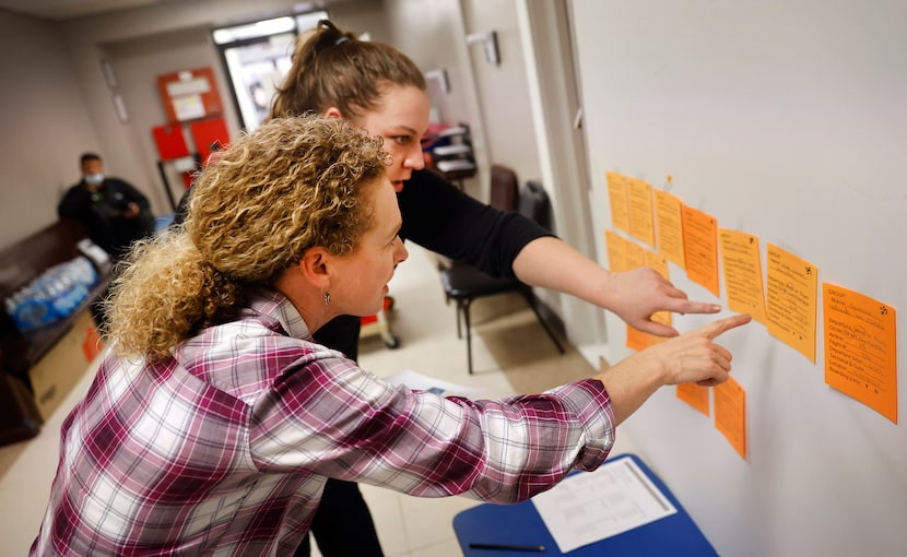 Volunteer Jennifer Stinson assists in arranging travel for migrants on a flight reminder...