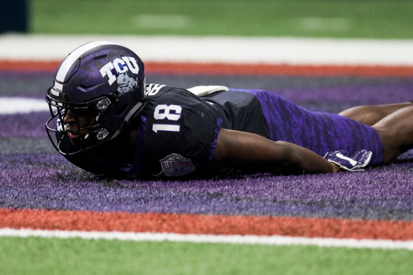 TCU Horned Frogs wide receiver Jalen Reagor (18) lays in a purple portion of the end zone as...