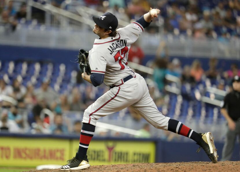 Atlanta Braves relief pitcher Luke Jackson (77) throws during the 10th inning of a baseball...