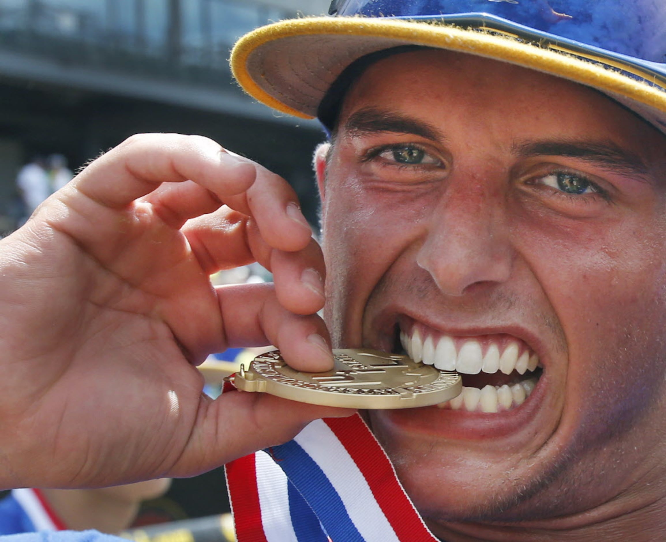 Sunnyvale's Ryan Cottingame tests his UIL medal as he celebrates after the Raiders' 13-3...