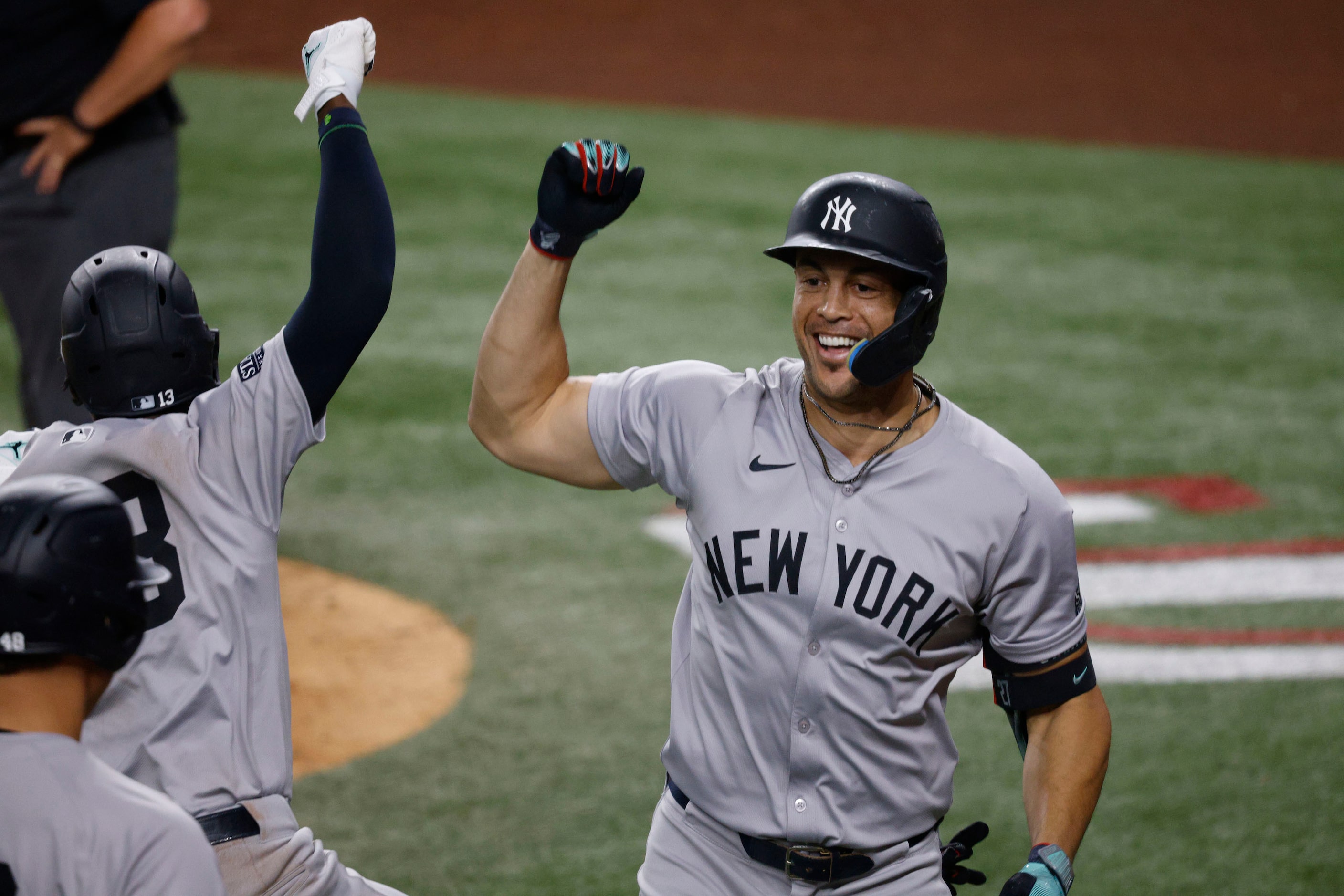 New York Yankees designated hitter Giancarlo Stanton (27)  celebrates with his teammates...