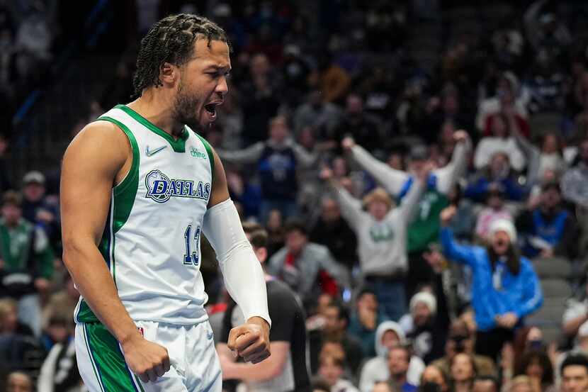 Dallas Mavericks guard Jalen Brunson celebrates after picking up a basket and a foul during...