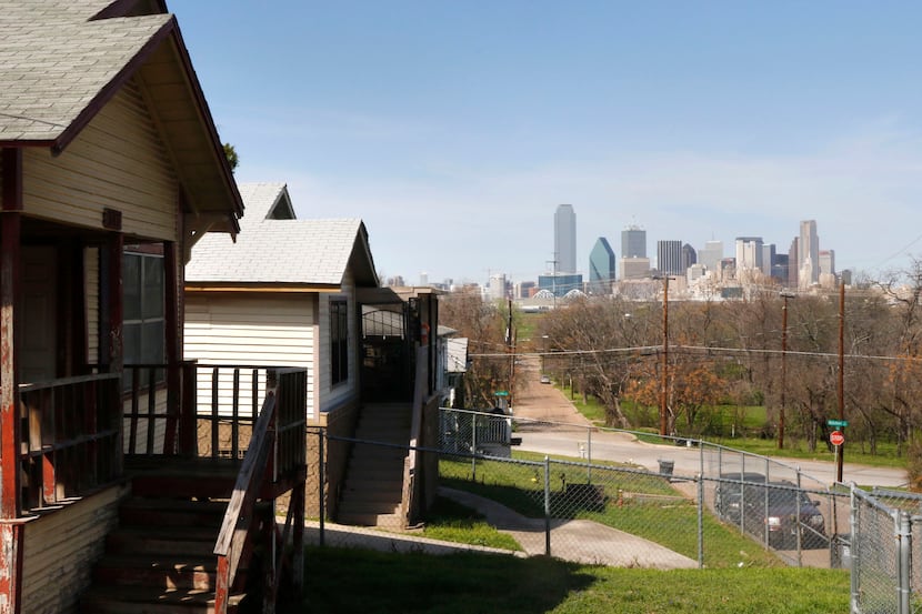 The Dallas skyline looms across the Trinity River from homes appraised at around...