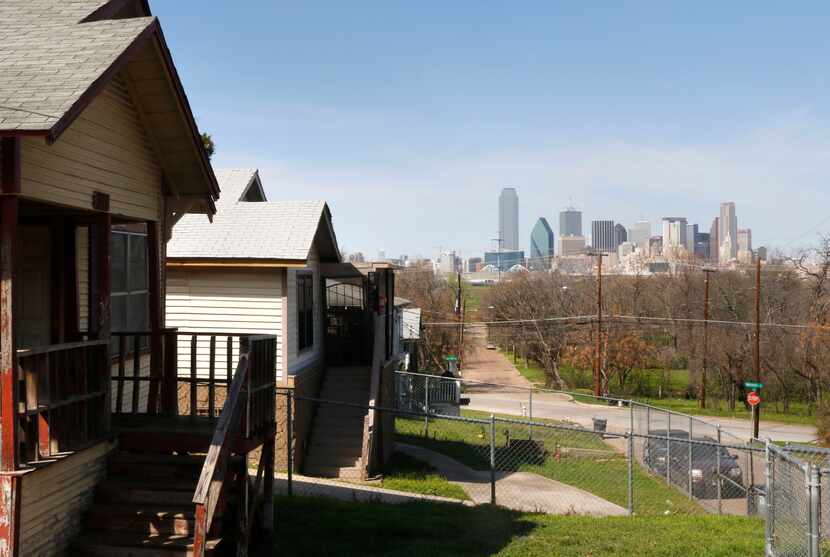 The Dallas skyline looms across the Trinity River from homes appraised at around...
