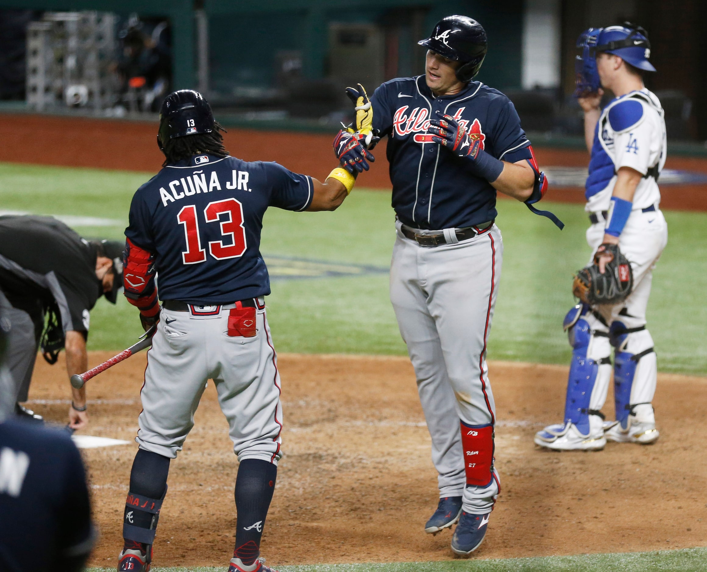 Atlanta Braves third baseman Austin Riley (27) celebrates with Atlanta Braves center fielder...