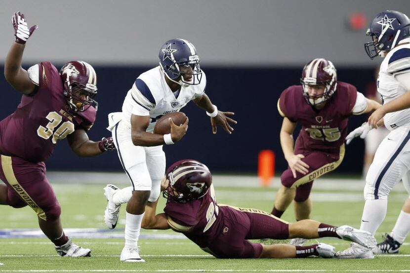 Lone Star's Jason Shelley (18) evades the grasp of Heritage's Jarred Brown (27) on a play in...