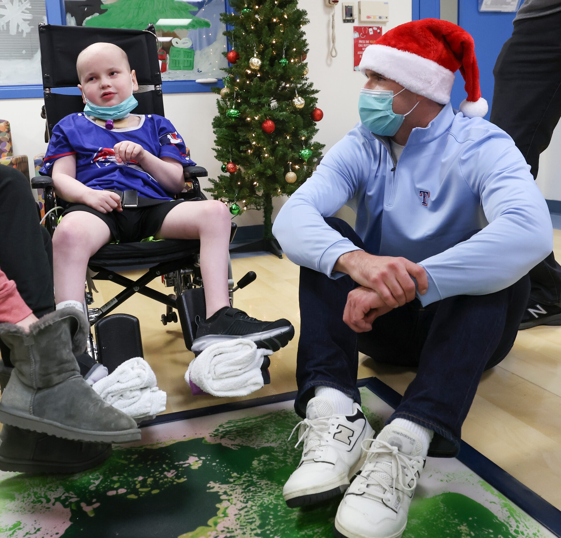 Texas Rangers pitcher John King listens to Caleb Larson, 8,  at Medical City Children’s...