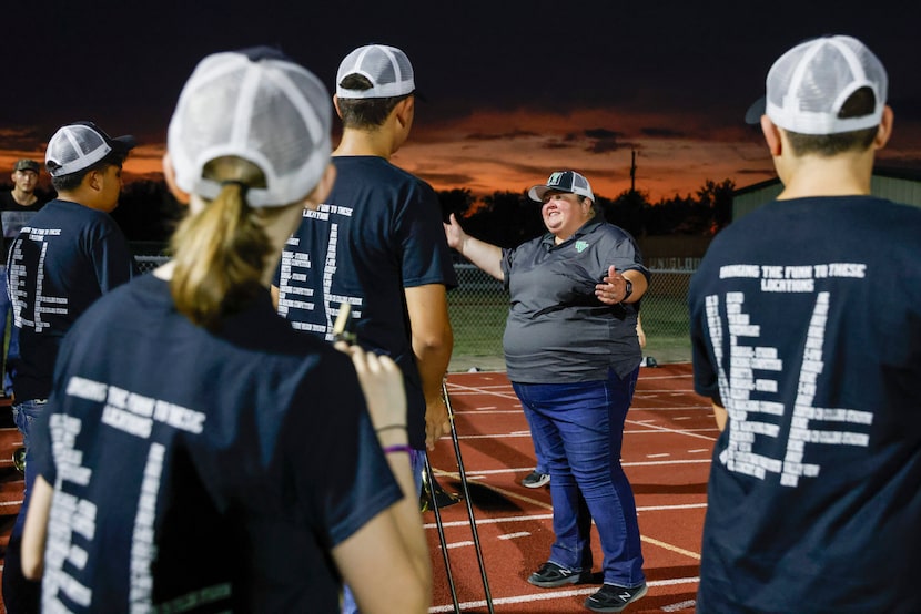 Valley View High School band director Shannon Worley talks with band members after their...