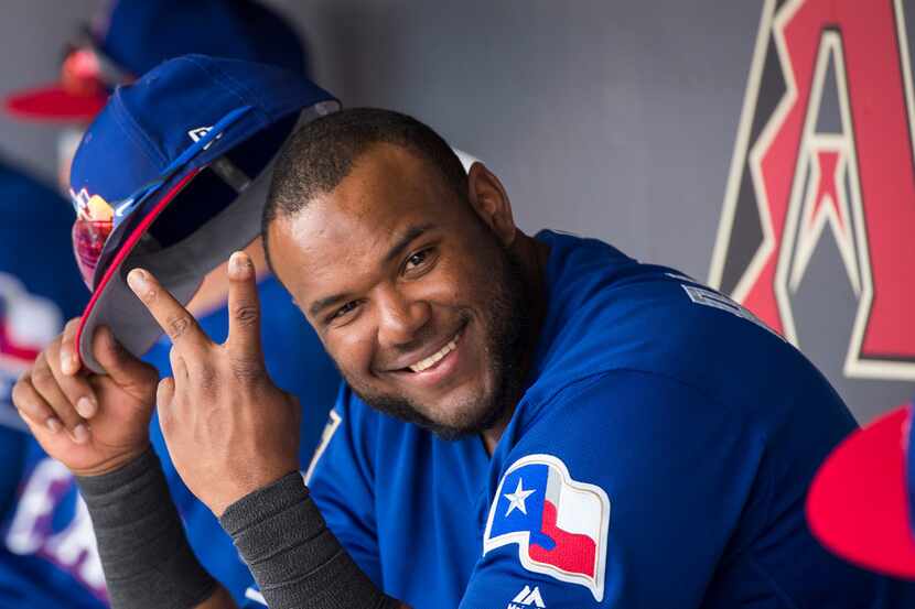 Texas Rangers infielder Hanser Alberto hams it up in the dugout during the second inning of...