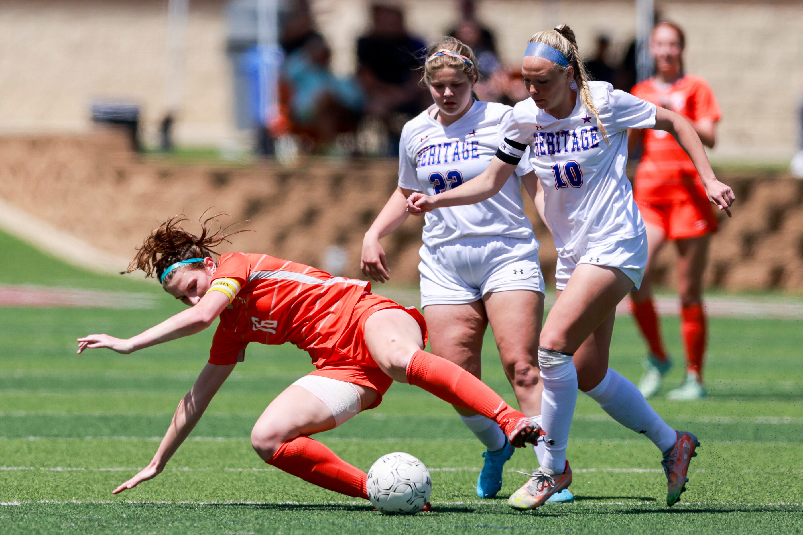 Celina forward Taylor Zdrojewski (16) falls to the ground ahead of Midlothian Heritage...