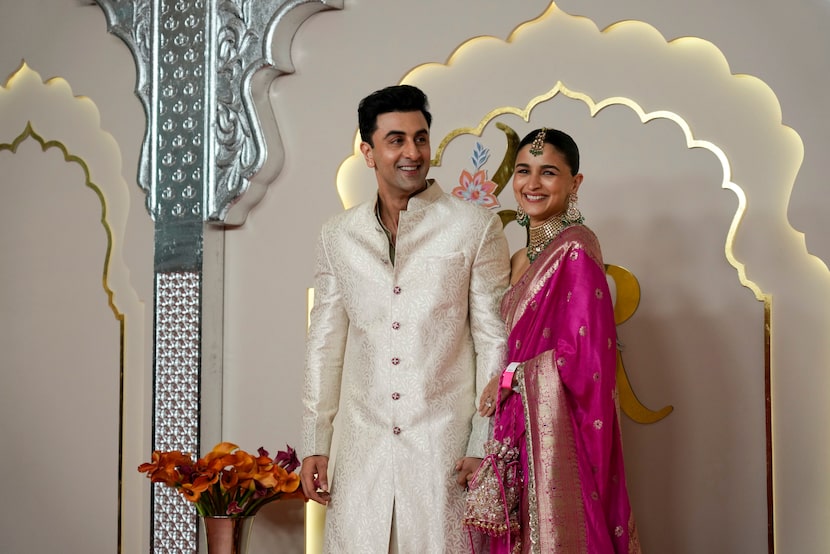 Bollywood actor couple Ranbir Kapoor and Alia Bhatt pose for a photograph at the wedding of...