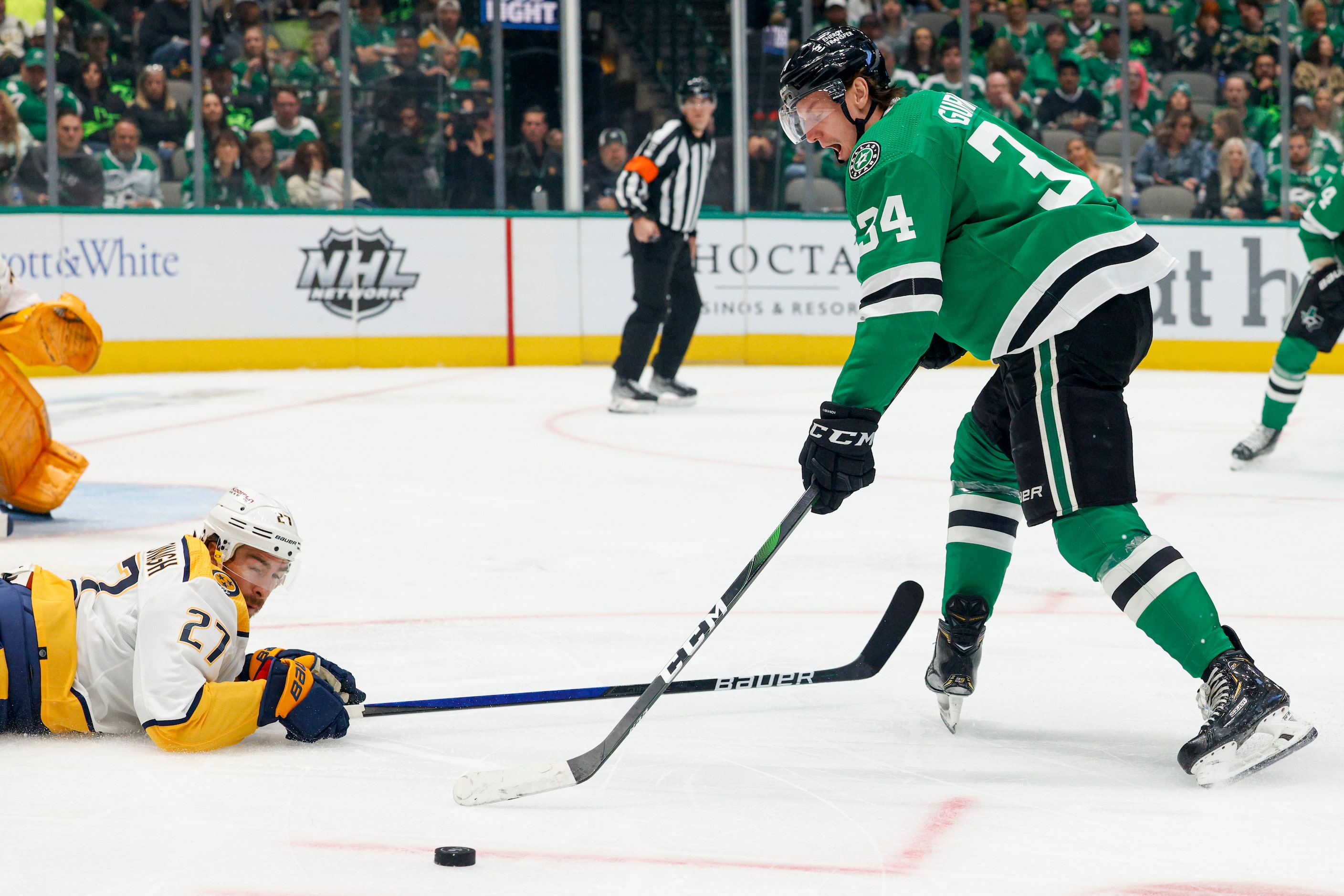 Dallas Stars right wing Denis Gurianov (34) pushes the puck around a diving Nashville...