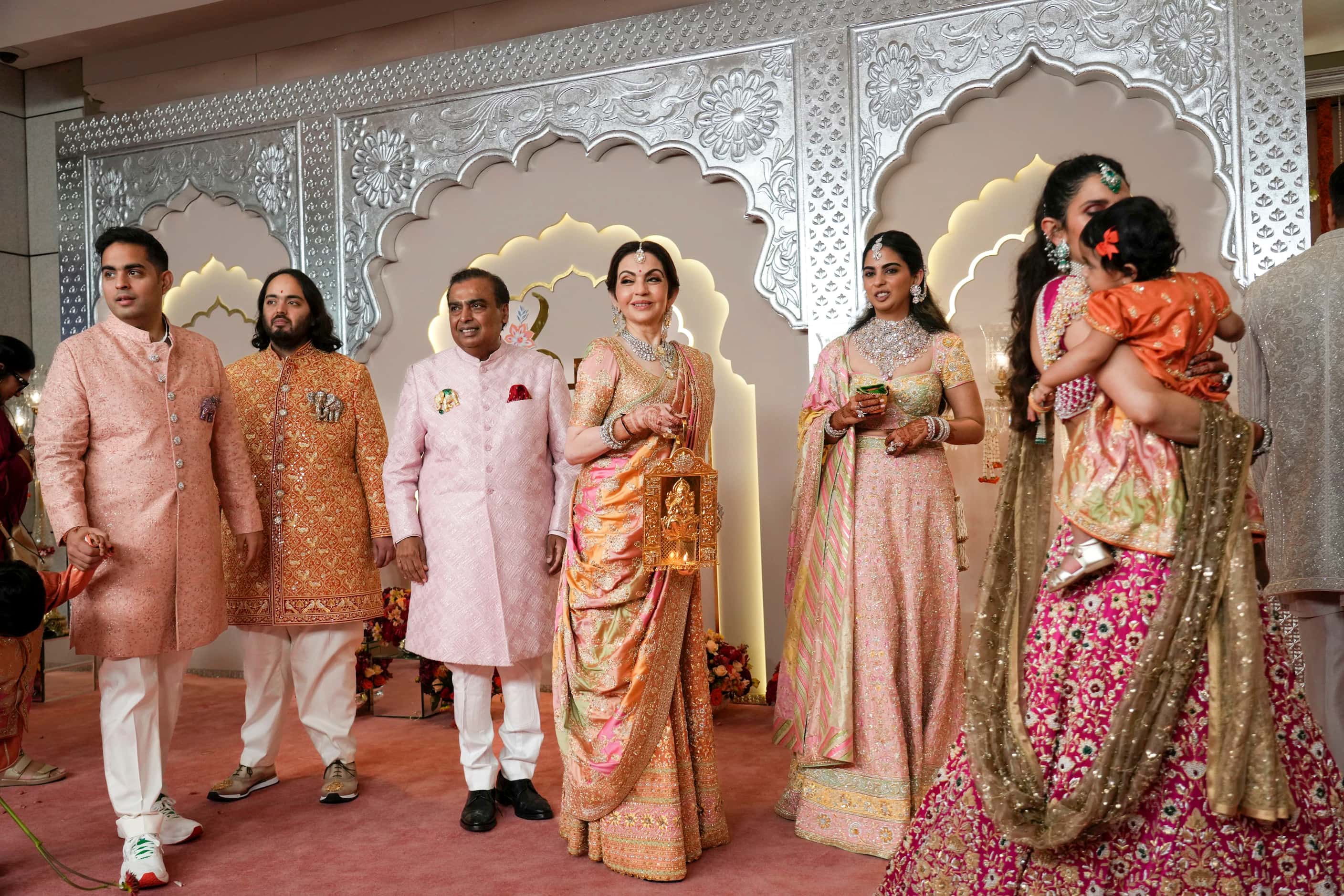 Billionaire Mukesh Ambani, third left, stands with his family members from left to right,...